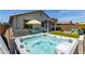 Luxurious backyard with a hot tub, seating area, and well-maintained landscaping at 25289 N 143Rd Dr, Surprise, AZ 85387