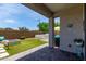Spacious backyard featuring a modern outdoor lounge, lush artificial grass, and a relaxing jacuzzi, ideal for outdoor living at 25289 N 143Rd Dr, Surprise, AZ 85387