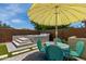 Entertaining backyard with a hot tub, outdoor seating under a striped umbrella at 25289 N 143Rd Dr, Surprise, AZ 85387