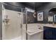 Elegant bathroom featuring a modern shower, soaking tub, dark accent wall, and stylish light fixtures at 25289 N 143Rd Dr, Surprise, AZ 85387