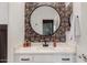 Stylish bathroom with modern sink, decorative wallpaper, and round mirror at 25289 N 143Rd Dr, Surprise, AZ 85387