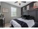 Well-lit bedroom with a ceiling fan, a large window, and decorative wall art at 25289 N 143Rd Dr, Surprise, AZ 85387