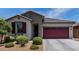 Charming single-story home featuring a two-car garage, well-kept landscaping, and a stylish facade at 25289 N 143Rd Dr, Surprise, AZ 85387