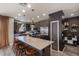 Kitchen featuring a large island with seating, stainless steel appliances, and stylish pendant lighting at 25289 N 143Rd Dr, Surprise, AZ 85387