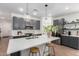 Modern kitchen featuring an island with counter seating, stainless steel appliances, and designer pendant lighting at 3053 W Straight Arrow Ln, Phoenix, AZ 85083