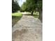Stone walkway under mature trees, creating a peaceful and inviting entry to the property at 3102 E Backus Rd, Mesa, AZ 85213