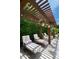 Backyard featuring lounge chairs under a wooden pergola with hanging flower baskets at 3511 N 39Th Pl, Phoenix, AZ 85018