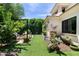 Landscaped backyard with manicured lawn, seating area, and a charming outdoor bench at 3511 N 39Th Pl, Phoenix, AZ 85018