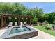 Backyard featuring a tiled pool with a fountain, lounge chairs and lush, green landscaping at 3511 N 39Th Pl, Phoenix, AZ 85018