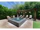 Backyard featuring a tiled pool with a fountain, lounge chairs and lush, green landscaping at 3511 N 39Th Pl, Phoenix, AZ 85018