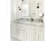 Bright bathroom features marble countertops, white cabinets and modern fixtures at 3511 N 39Th Pl, Phoenix, AZ 85018