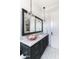 Elegant bathroom with marble countertops, black cabinets and pendant lighting at 3511 N 39Th Pl, Phoenix, AZ 85018