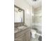 Bright bathroom featuring a gray vanity, updated shower, and elegant crystal light fixture at 3511 N 39Th Pl, Phoenix, AZ 85018