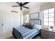 Bright bedroom boasts a cozy bed with a blue striped comforter, and windows with light filtering window treatments at 3511 N 39Th Pl, Phoenix, AZ 85018