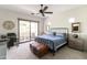 Inviting bedroom featuring a walk-out balcony, neutral walls, and a cozy bed with a comfy leather bench at 3511 N 39Th Pl, Phoenix, AZ 85018