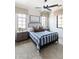 Comfortable bedroom featuring a blue striped comforter, ceiling fan, and neutral-toned walls and window treatments at 3511 N 39Th Pl, Phoenix, AZ 85018