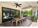 Inviting covered patio with a dining table, outdoor grill, and sliding door access at 3511 N 39Th Pl, Phoenix, AZ 85018