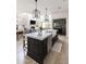 Kitchen with white cabinets, dark island, marble countertops, and a glass-enclosed wine storage area at 3511 N 39Th Pl, Phoenix, AZ 85018