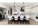 A kitchen with white cabinetry, marble countertops, a dark island, and stylish pendant lighting at 3511 N 39Th Pl, Phoenix, AZ 85018