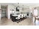 Spacious kitchen featuring white cabinets, marble countertops, a dark island, and stainless steel appliances at 3511 N 39Th Pl, Phoenix, AZ 85018