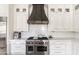 Close up of a kitchen featuring a stainless steel oven, marble backsplash, and white cabinets at 3511 N 39Th Pl, Phoenix, AZ 85018
