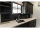Laundry room features dark cabinets, a window, light countertops, and a stainless steel sink at 3511 N 39Th Pl, Phoenix, AZ 85018