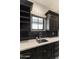 Laundry room features dark cabinets, a window, light countertops, and a stainless steel sink at 3511 N 39Th Pl, Phoenix, AZ 85018