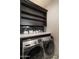 Modern laundry room with front load washer and dryer, dark cabinetry, quartz countertop, and decorative tile floor at 3511 N 39Th Pl, Phoenix, AZ 85018