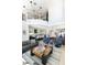 Open-concept living area with a fireplace, sofa, kitchen, and a staircase leading to a balcony at 3511 N 39Th Pl, Phoenix, AZ 85018