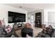 Spacious living room featuring a large TV, comfortable seating, and a view into the sport themed bedroom at 3511 N 39Th Pl, Phoenix, AZ 85018
