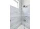Detailed view of the shower with white marble tile walls at 3511 N 39Th Pl, Phoenix, AZ 85018