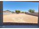 View of a spacious backyard with dirt and block wall, ready for a new owner's personal touch at 37172 W Parador Ln, Maricopa, AZ 85138