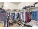 Walk-in closet featuring shelving and hanging space for clothing and shoe racks at 41005 W Crane Dr, Maricopa, AZ 85138