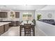 Open dining room with a large table and chairs, seamlessly connected to the kitchen and living room, ideal for Gathering gatherings at 41005 W Crane Dr, Maricopa, AZ 85138