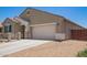 Attractive single-story home with a two-car garage and low-maintenance desert landscaping at 41005 W Crane Dr, Maricopa, AZ 85138