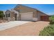 Attractive single-story home with a two-car garage and low-maintenance desert landscaping at 41005 W Crane Dr, Maricopa, AZ 85138