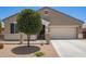 Charming single-story home featuring desert landscaping, a two-car garage, and a welcoming front porch at 41005 W Crane Dr, Maricopa, AZ 85138