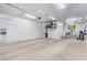 Spacious garage with overhead lighting, sealed floor, and organized storage solutions at 41005 W Crane Dr, Maricopa, AZ 85138