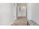 Inviting hallway with neutral colors and flooring, offering a seamless transition between rooms at 41005 W Crane Dr, Maricopa, AZ 85138