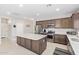 Well-equipped kitchen with an island and stainless steel appliances, perfect for culinary enthusiasts and entertaining guests at 41005 W Crane Dr, Maricopa, AZ 85138