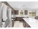Modern kitchen with stainless steel appliances, a center island and lots of natural light, perfect for preparing meals at 41005 W Crane Dr, Maricopa, AZ 85138