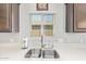 Close up on the kitchen sink with a window view, clean countertops, and stylish fixtures at 41005 W Crane Dr, Maricopa, AZ 85138
