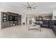 Open-concept living space featuring modern furnishings and a built-in entertainment center at 41005 W Crane Dr, Maricopa, AZ 85138