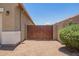 Wooden side gate for yard access at 41005 W Crane Dr, Maricopa, AZ 85138