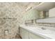 This bathroom features a double sink with decorative wallpaper at 4402 W El Caminito Dr, Glendale, AZ 85302