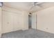 This bedroom features gray carpet, and a closet providing ample storage at 4402 W El Caminito Dr, Glendale, AZ 85302