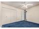 This bedroom features a closet, carpet and ceiling fan at 4402 W El Caminito Dr, Glendale, AZ 85302