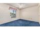 This bedroom features a light blue carpet, and floral wallpaper design at 4402 W El Caminito Dr, Glendale, AZ 85302