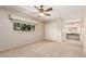 Bright bedroom featuring a ceiling fan, neutral paint and carpet, and closet at 4402 W El Caminito Dr, Glendale, AZ 85302
