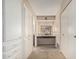 Hallway featuring custom cabinets, closet, and a vanity with accent lighting at 4402 W El Caminito Dr, Glendale, AZ 85302